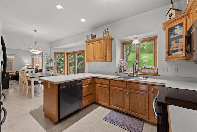 1500 Wolf Dr, West Bend, WI 53090 - kitchen featuring dishwasher, a sink, a peninsula, light countertops, and recessed lighting