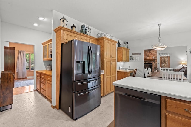 1500 Wolf Dr, West Bend, WI 53090 - kitchen featuring stainless steel appliances, light countertops, decorative light fixtures, and a fireplace