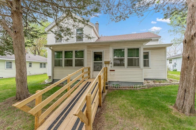 407 E Franklin St, Portage, WI 53901 - view of front of home featuring a chimney, a front lawn, and roof with shingles