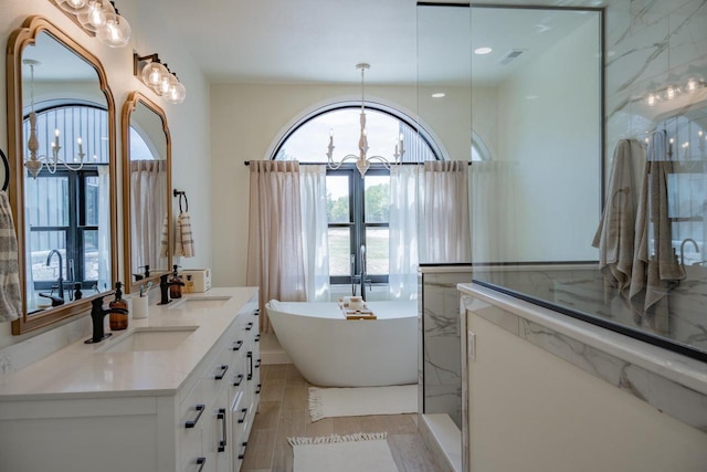 W5613 37th St, New Lisbon, WI 53950 - bathroom with a soaking tub, double vanity, and a chandelier