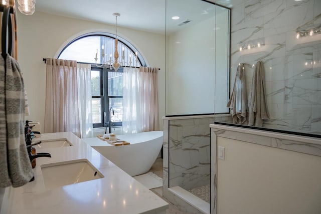 W5613 37th St, New Lisbon, WI 53950 - full bathroom with a marble finish shower, a freestanding bath, a chandelier, and double vanity