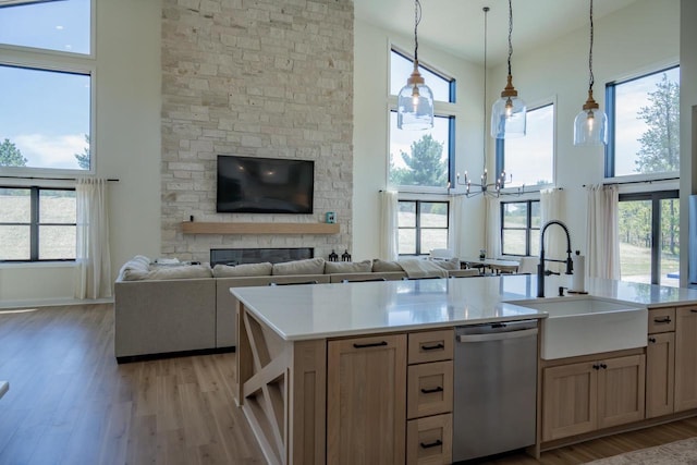 W5613 37th St, New Lisbon, WI 53950 - kitchen with stainless steel dishwasher, a sink, a high ceiling, and light wood finished floors