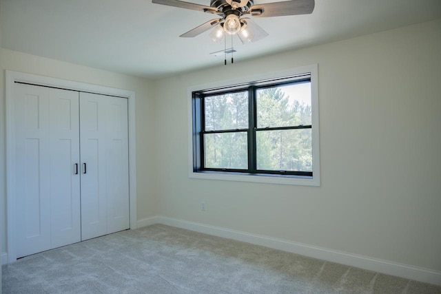 W5613 37th St, New Lisbon, WI 53950 - unfurnished bedroom featuring light carpet, baseboards, a closet, and a ceiling fan