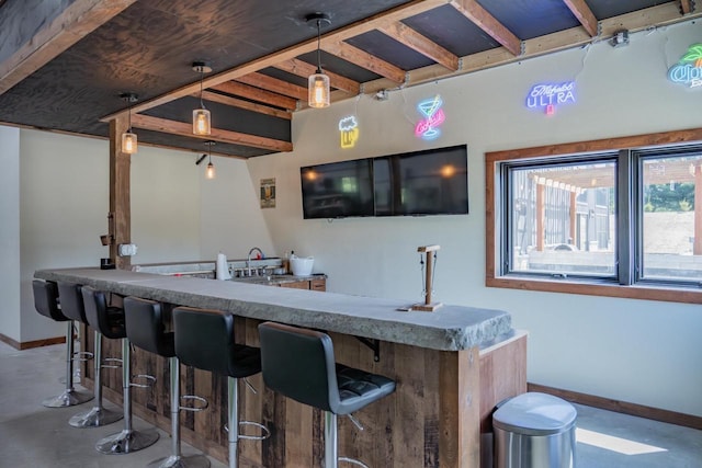 W5613 37th St, New Lisbon, WI 53950 - indoor wet bar featuring concrete flooring, baseboards, beam ceiling, and hanging light fixtures