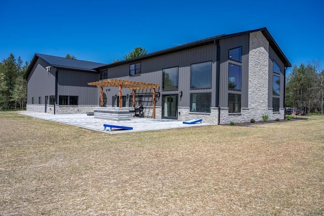 W5613 37th St, New Lisbon, WI 53950 - back of property featuring a pergola, stone siding, a patio, and a yard