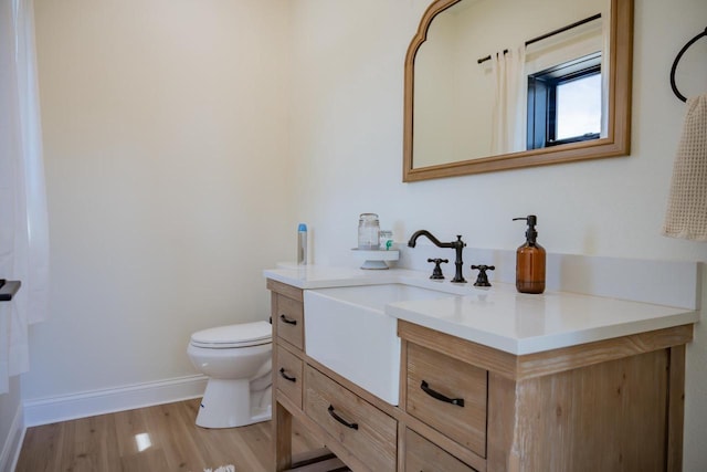 W5613 37th St, New Lisbon, WI 53950 - bathroom with vanity, toilet, baseboards, and wood finished floors