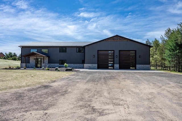 W5613 37th St, New Lisbon, WI 53950 - modern inspired farmhouse with driveway, metal roof, and an attached garage