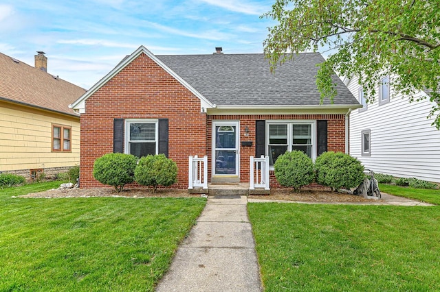 134 W Roberta Ave, Waukesha, WI 53186 - view of front facade with brick siding, roof with shingles, and a front yard