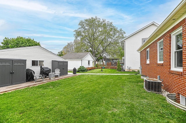 134 W Roberta Ave, Waukesha, WI 53186 - view of green lawn with a shed, central AC unit, and an outdoor structure