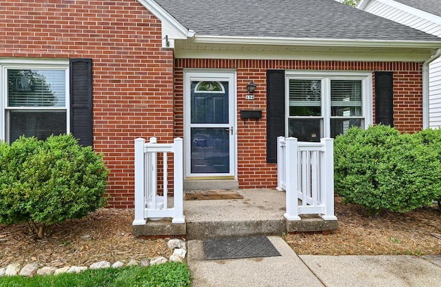 134 W Roberta Ave, Waukesha, WI 53186 - doorway to property featuring roof with shingles and brick siding
