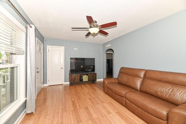 134 W Roberta Ave, Waukesha, WI 53186 - living area featuring arched walkways, a ceiling fan, light wood-style floors, and baseboards
