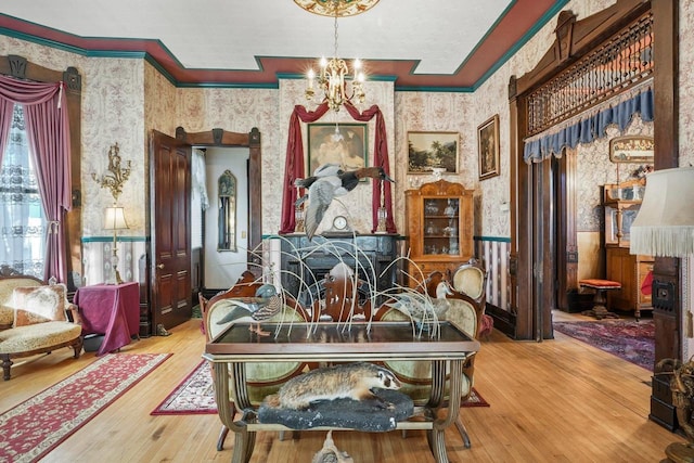 503 E Conant St, Portage, WI 53901 - living area featuring wallpapered walls, a wainscoted wall, ornamental molding, hardwood / wood-style flooring, and a chandelier
