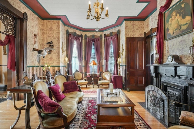 503 E Conant St, Portage, WI 53901 - living area featuring wallpapered walls, ornamental molding, wood finished floors, and a chandelier