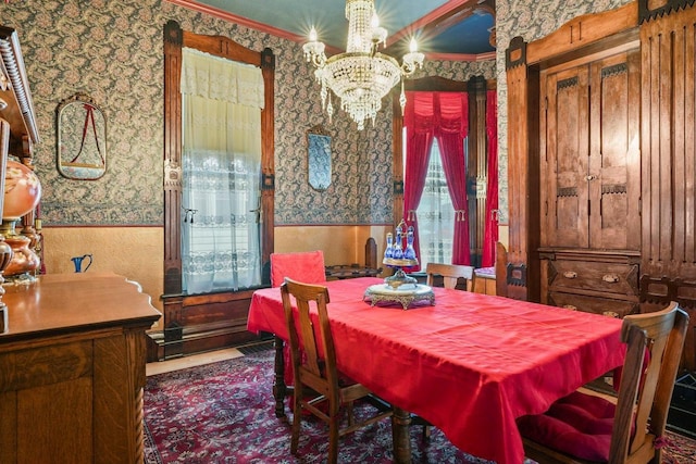 503 E Conant St, Portage, WI 53901 - dining space with wallpapered walls, wainscoting, a chandelier, and ornamental molding
