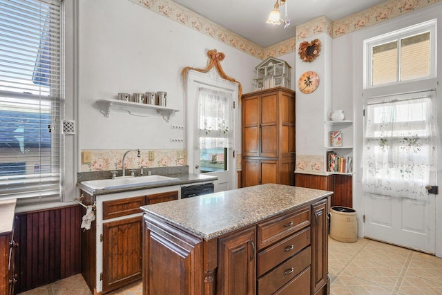 503 E Conant St, Portage, WI 53901 - kitchen featuring a sink, open shelves, brown cabinets, and a center island