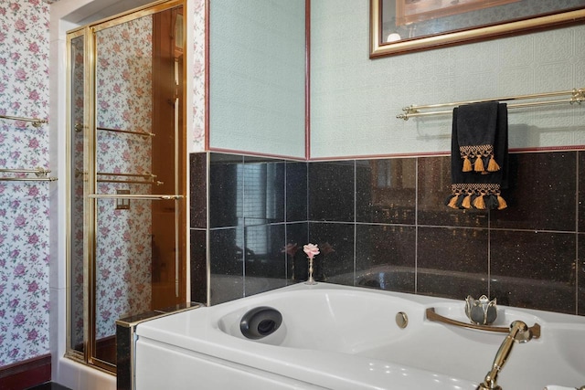 503 E Conant St, Portage, WI 53901 - bathroom featuring wallpapered walls, a bath, and a stall shower