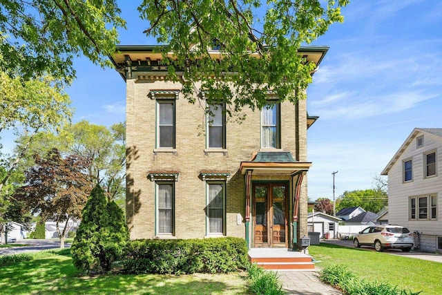 503 E Conant St, Portage, WI 53901 - italianate home with a front lawn and brick siding