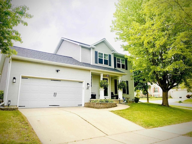 5438 Park Meadow Dr, Madison, WI 53704 - view of front of house with driveway, an attached garage, a front yard, and covered porch