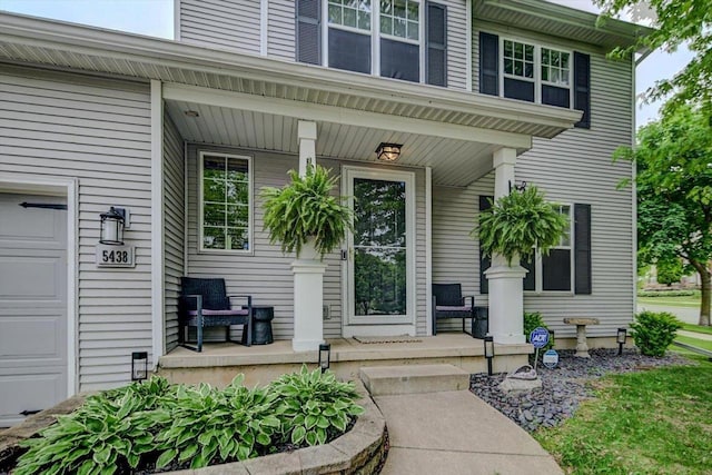5438 Park Meadow Dr, Madison, WI 53704 - doorway to property featuring covered porch and a garage