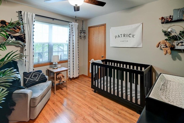 5438 Park Meadow Dr, Madison, WI 53704 - bedroom with light wood-style floors, ceiling fan, and a nursery area