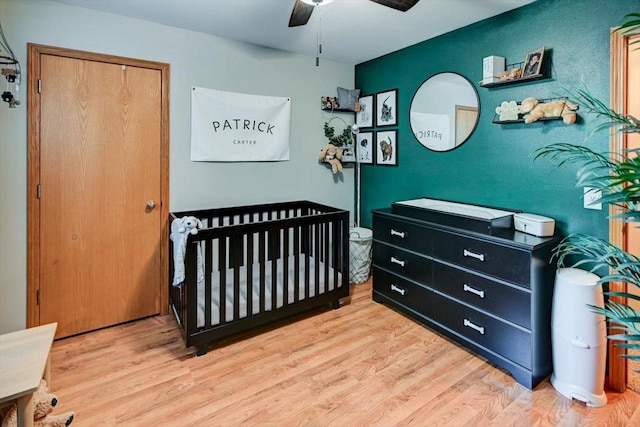 5438 Park Meadow Dr, Madison, WI 53704 - bedroom featuring wood finished floors, ceiling fan, and a nursery area