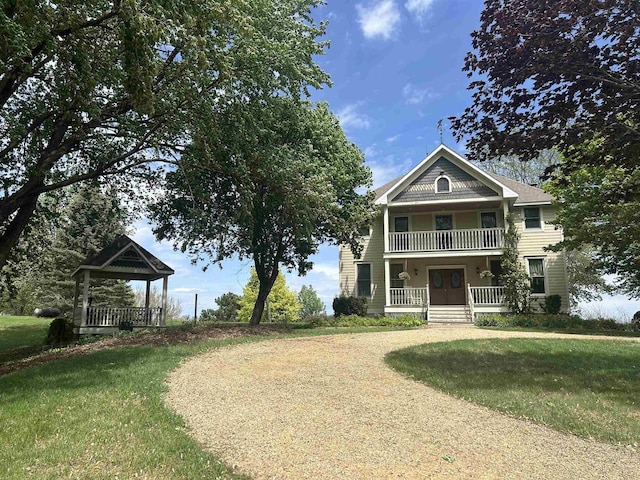 13412 Glacier Rd, Tomah, WI 54660 - view of front facade with a porch, a front lawn, and a balcony