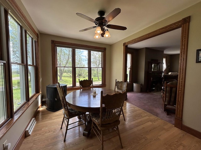 13412 Glacier Rd, Tomah, WI 54660 - dining area featuring light wood-type flooring, ceiling fan, baseboards, and a baseboard radiator