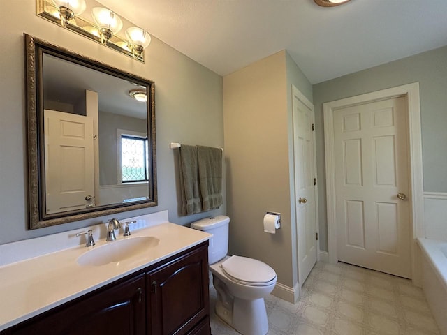13412 Glacier Rd, Tomah, WI 54660 - bathroom featuring a bathtub, tile patterned floors, toilet, vanity, and baseboards