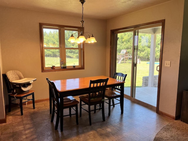 N3480 Feathers Ct, Waupaca, WI 54981 - dining space featuring a chandelier, plenty of natural light, and baseboards