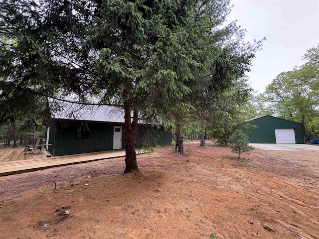 N4755 11th Dr, Montello, WI 53949 - view of front facade featuring a deck, a detached garage, and an outbuilding