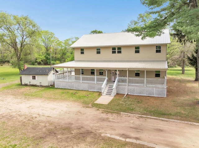 W6870 Czech Ln, Neshkoro, WI 54960 - farmhouse-style home featuring a porch, metal roof, an outbuilding, and a front yard