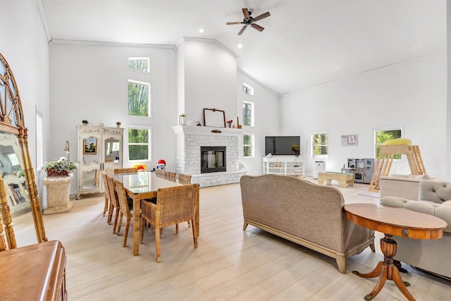 W6870 Czech Ln, Neshkoro, WI 54960 - living room featuring high vaulted ceiling, ornamental molding, ceiling fan, a glass covered fireplace, and healthy amount of natural light