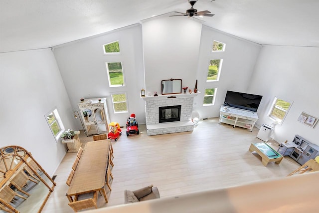 W6870 Czech Ln, Neshkoro, WI 54960 - living area with high vaulted ceiling, a ceiling fan, a glass covered fireplace, and wood finished floors