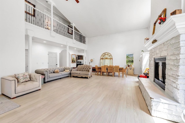W6870 Czech Ln, Neshkoro, WI 54960 - living area with high vaulted ceiling, light wood-style floors, a stone fireplace, and ceiling fan