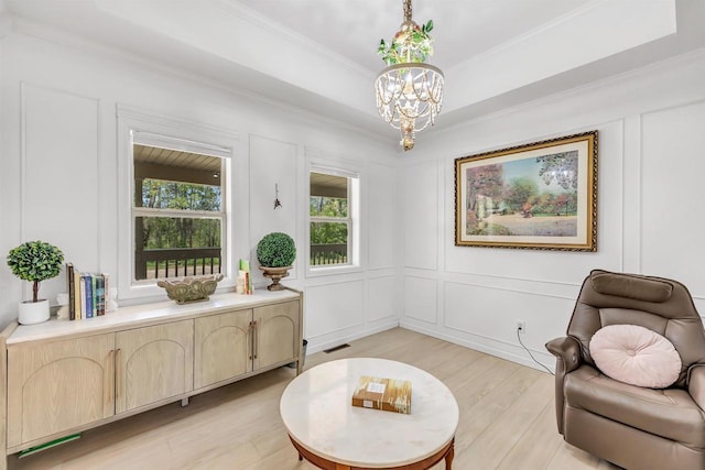 W6870 Czech Ln, Neshkoro, WI 54960 - sitting room featuring a chandelier, light wood-style flooring, crown molding, and a decorative wall