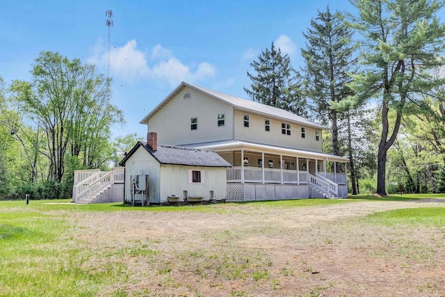 W6870 Czech Ln, Neshkoro, WI 54960 - back of house with stairs, covered porch, a lawn, and metal roof