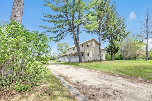 W6870 Czech Ln, Neshkoro, WI 54960 - view of front of house with a front yard, dirt driveway, and a porch