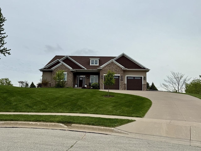 515 Fieldstone Ct, Tomah, WI 54660 - craftsman-style home featuring a front lawn, driveway, a garage, and brick siding