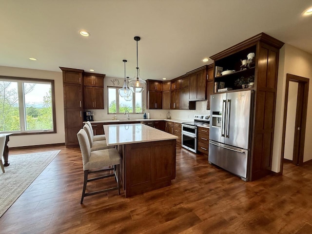 515 Fieldstone Ct, Tomah, WI 54660 - kitchen featuring appliances with stainless steel finishes, a sink, plenty of natural light, a center island, and recessed lighting
