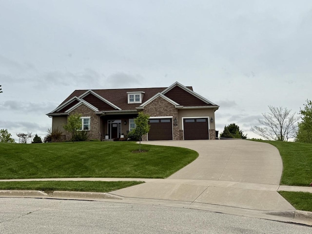515 Fieldstone Ct, Tomah, WI 54660 - craftsman-style house featuring a front lawn, concrete driveway, a garage, stone siding, and brick siding
