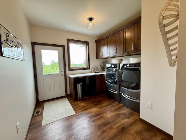 515 Fieldstone Ct, Tomah, WI 54660 - laundry area featuring independent washer and dryer, cabinet space, dark wood finished floors, and baseboards