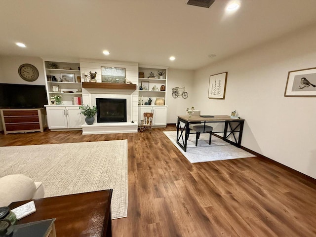 515 Fieldstone Ct, Tomah, WI 54660 - living room with a glass covered fireplace, dark wood-style flooring, baseboards, and recessed lighting