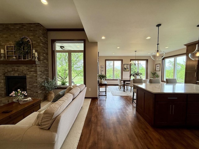 515 Fieldstone Ct, Tomah, WI 54660 - kitchen featuring open floor plan, dark wood-style floors, recessed lighting, pendant lighting, and dark brown cabinetry