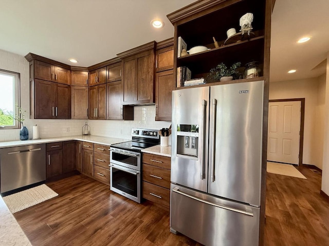 515 Fieldstone Ct, Tomah, WI 54660 - kitchen with stainless steel appliances, light countertops, dark wood-style floors, decorative backsplash, and recessed lighting