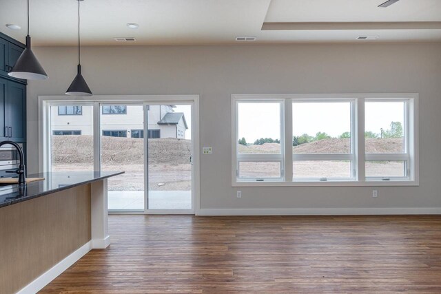 365 N Wilson St, Kimberly, WI 54136 - unfurnished living room featuring dark wood-style flooring, baseboards, and plenty of natural light