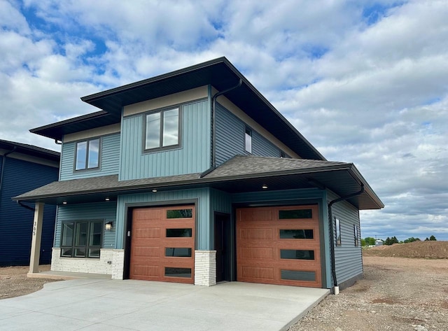 365 N Wilson St, Kimberly, WI 54136 - view of front facade featuring driveway, a shingled roof, brick siding, and board and batten siding