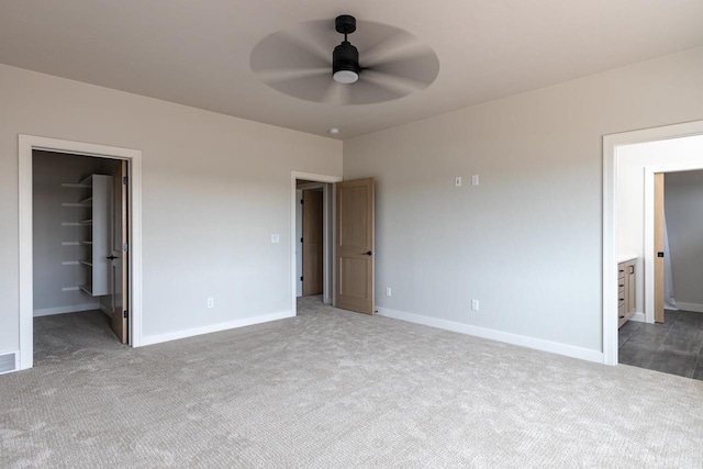 365 N Wilson St, Kimberly, WI 54136 - unfurnished bedroom featuring carpet, a walk in closet, baseboards, and ceiling fan