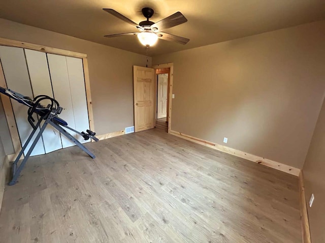 188 County Rd N, Birnamwood, WI 54414 - unfurnished bedroom featuring light wood-style flooring, baseboards, a closet, and a ceiling fan