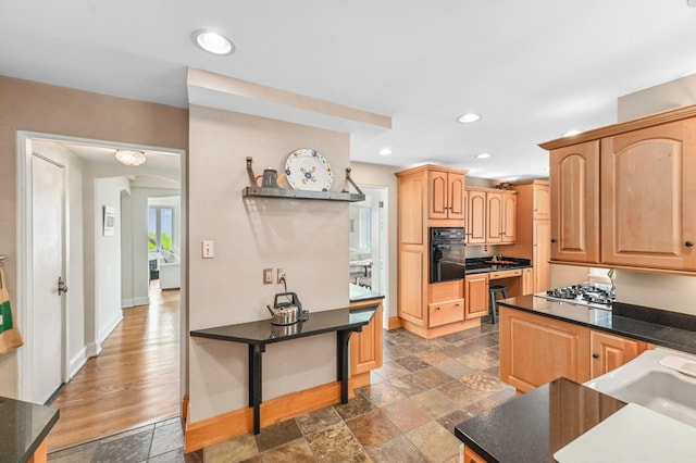 1830 E Kane Pl Unit 3, Milwaukee, WI 53202 - kitchen featuring black oven, baseboards, recessed lighting, stainless steel gas cooktop, and light brown cabinets
