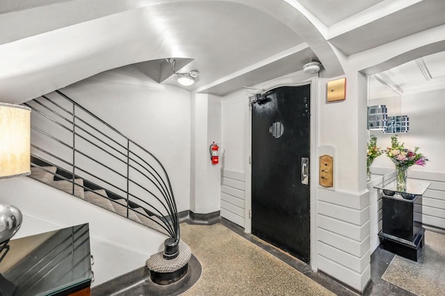 1830 E Kane Pl Unit 3, Milwaukee, WI 53202 - staircase featuring speckled floor, arched walkways, and baseboards